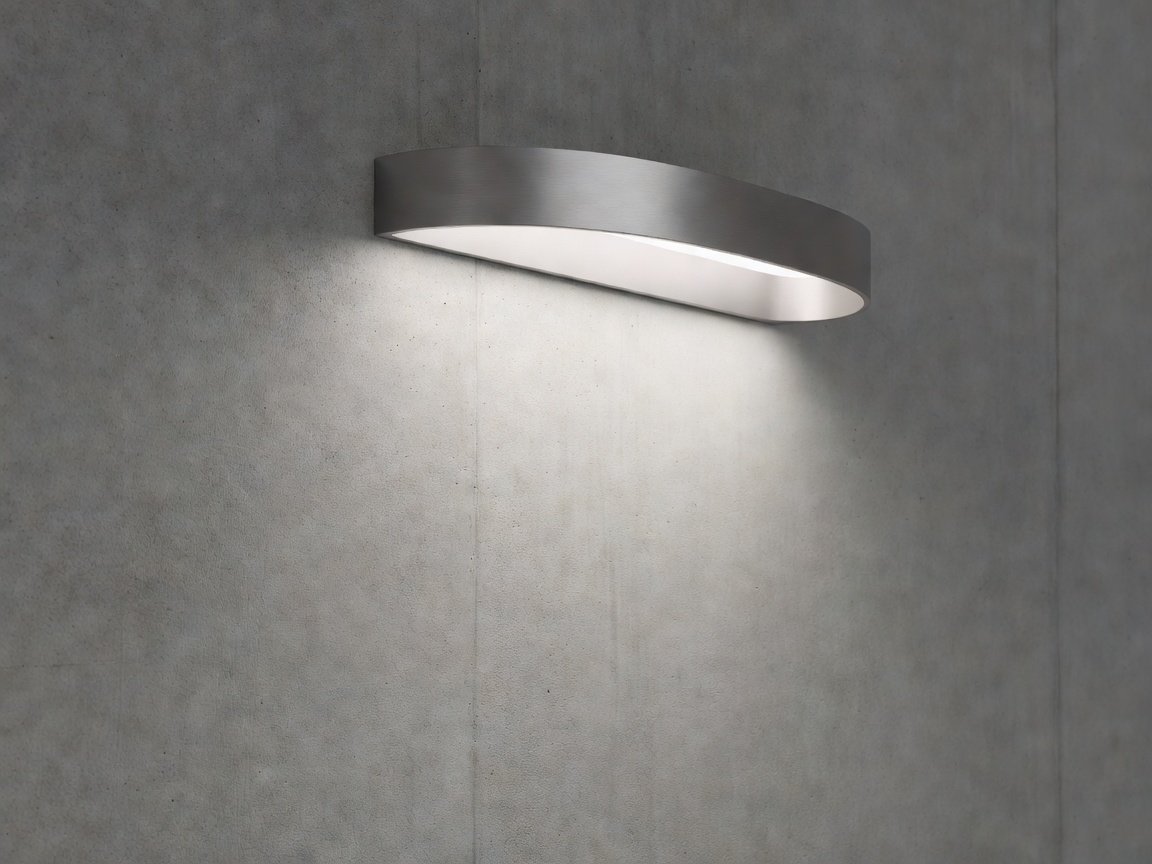 Sculptural architectural recessed luminaire casting clean gradient light along a concrete surface